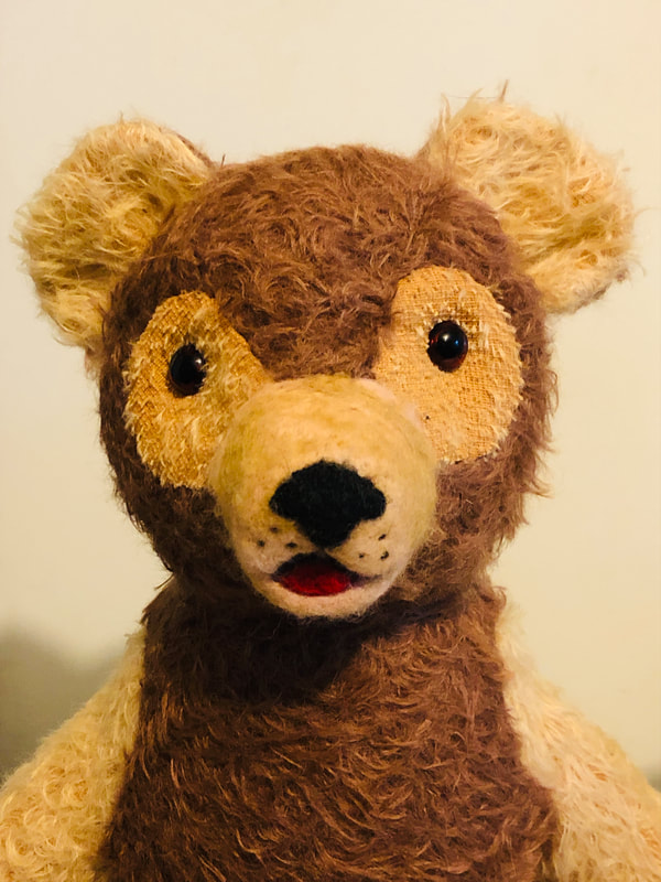 Gold and brown scruffy mohair teddy bear with needle-felted nose and mouth.