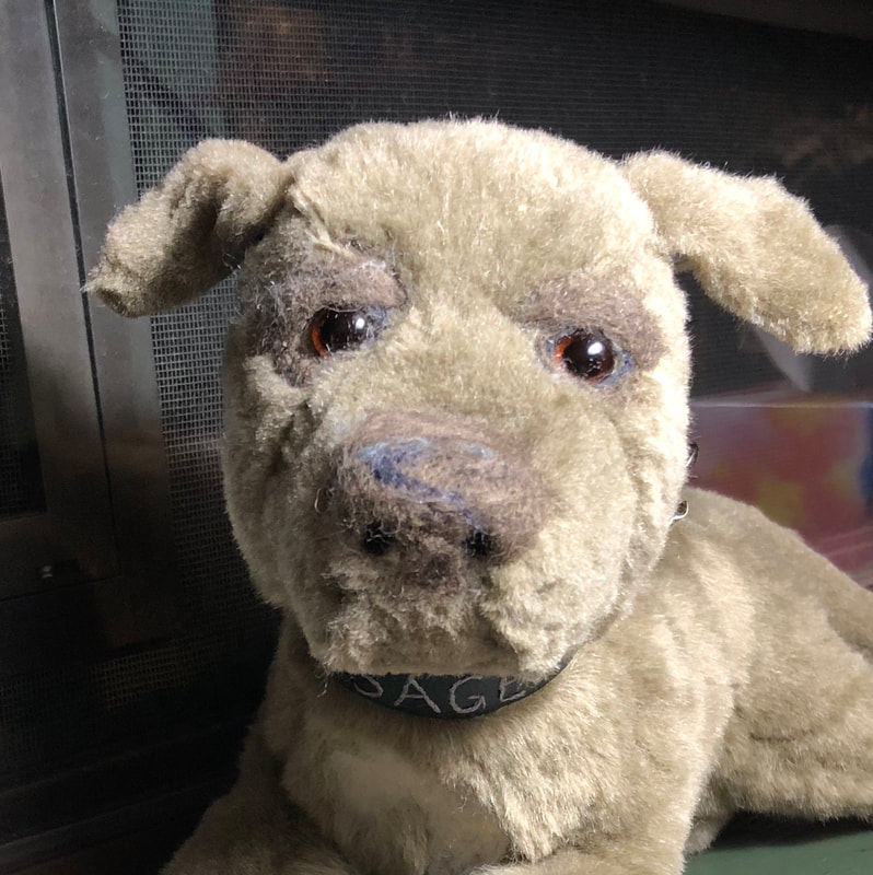 Grey staffordshire terrier plush, with darker grey needle felted features.